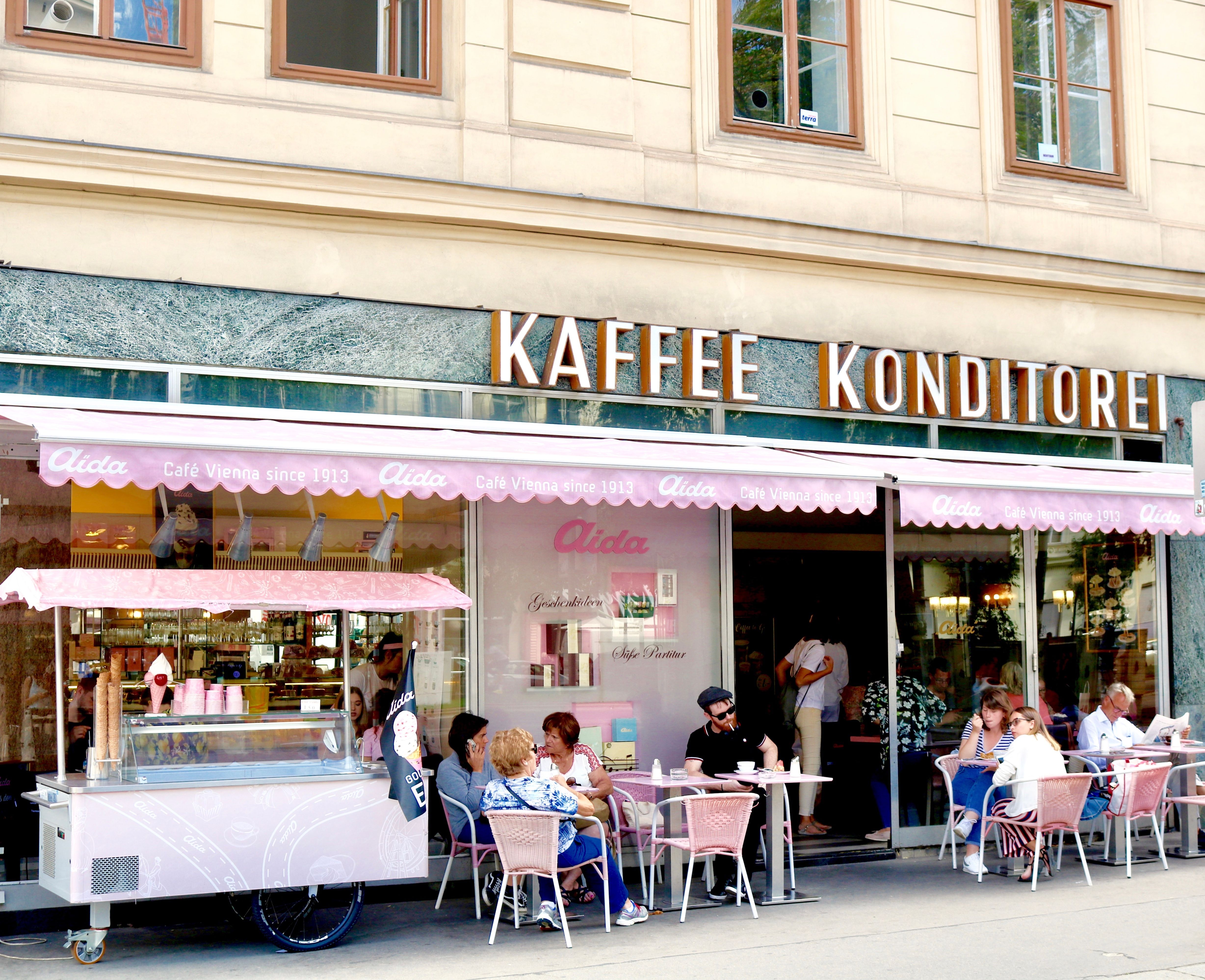 Outdoor seating at a traditional Viennese café, an inviting place to pause or meet someone over coffee.